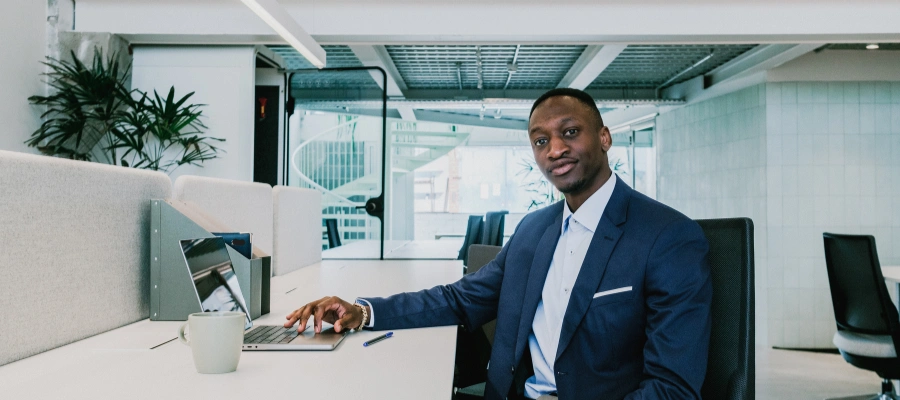 businessman sitting at desk with laptop