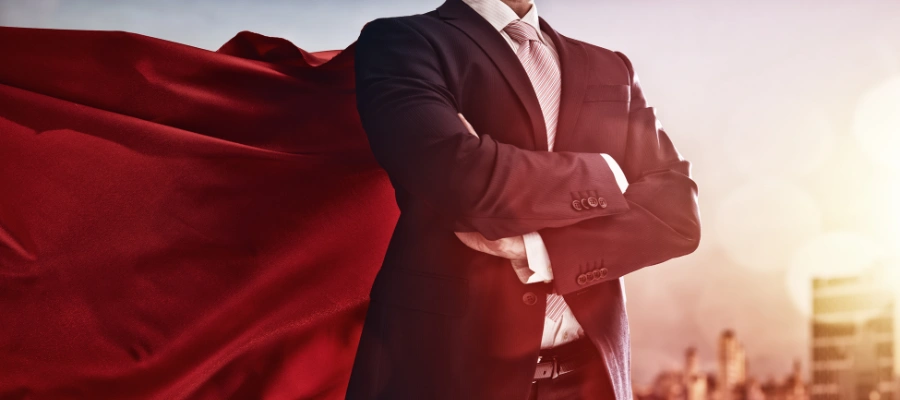 business professional wearing a red superhero cape